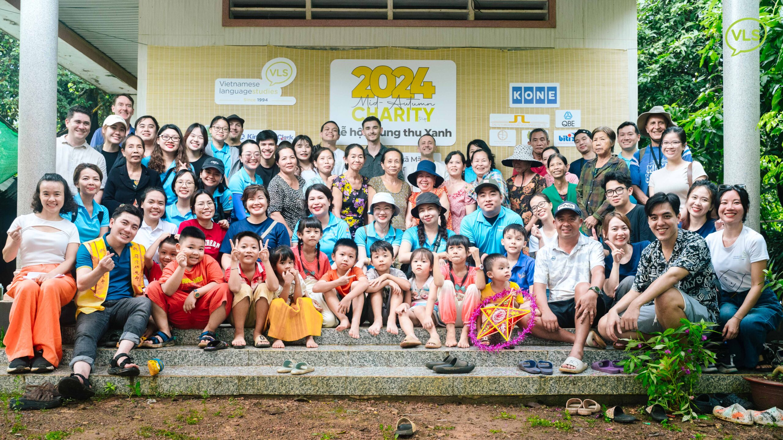 VLS volunteers and students delivering gifts and playing games with children during Mid-Autumn charity trip, part of CSR efforts.